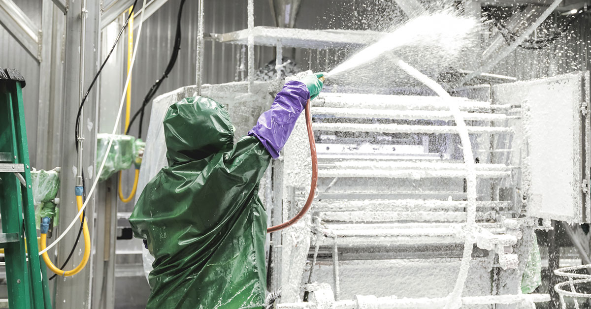 PSSI sanitation worker cleans a food processing facility